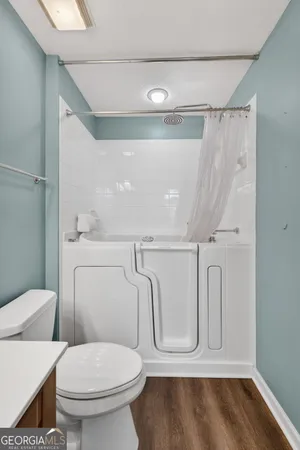 a bathroom with a toilet and a shower
