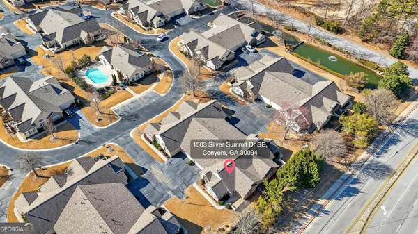 an aerial view of multiple houses with yard