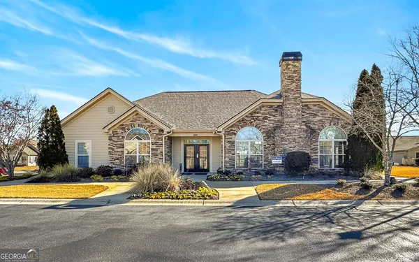 a view of a house with swimming pool yard and front view of a house