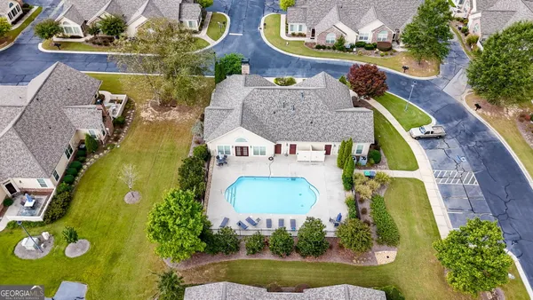 an aerial view of a house with a swimming pool