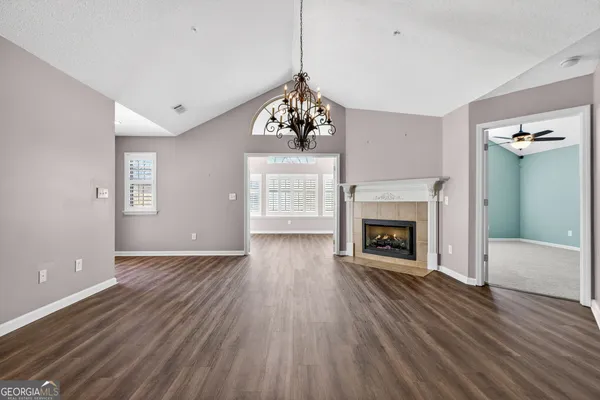 a living room with a fireplace with wooden floor
