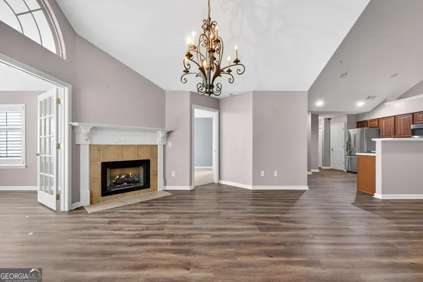a view of a livingroom with a fireplace window and a kitchen