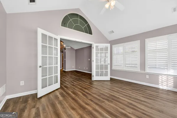 a view of wooden floor and windows in a room