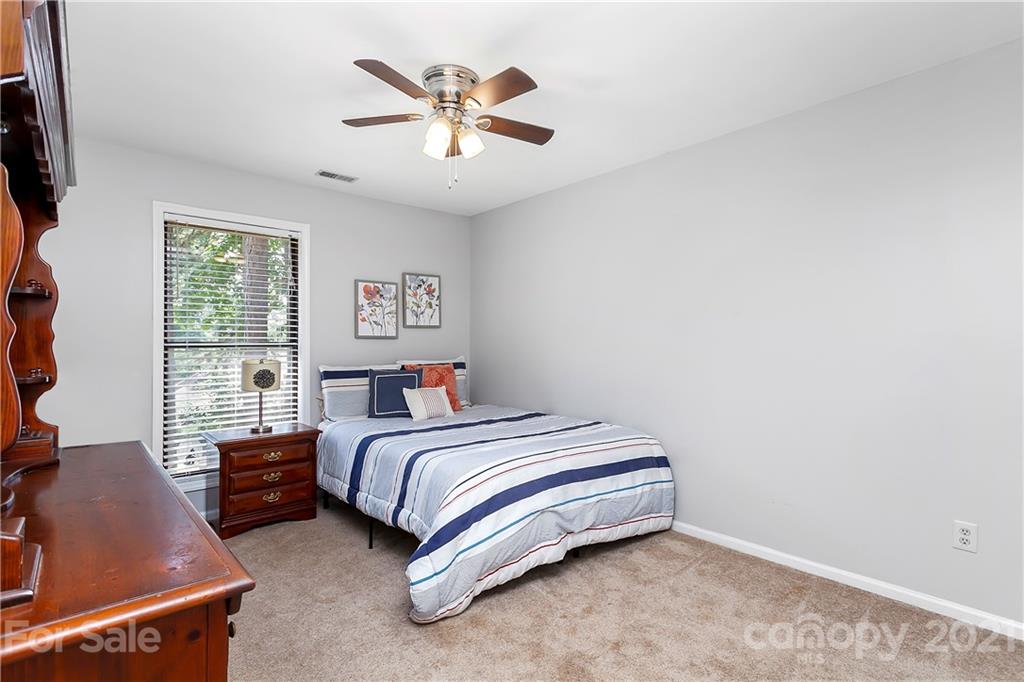 5063 Suwarrow Circle Tega Cay, SC 29708 - Photo 12 of 18 a spacious bedroom with a bed and a window