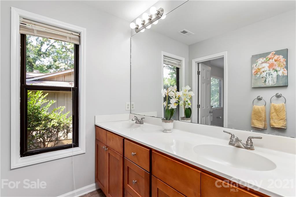 5063 Suwarrow Circle Tega Cay, SC 29708 - Photo 15 of 18 a bathroom with a double vanity sink and a mirror