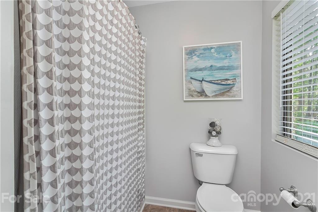 5063 Suwarrow Circle Tega Cay, SC 29708 - Photo 16 of 18 a bathroom with a toilet and a shower curtain