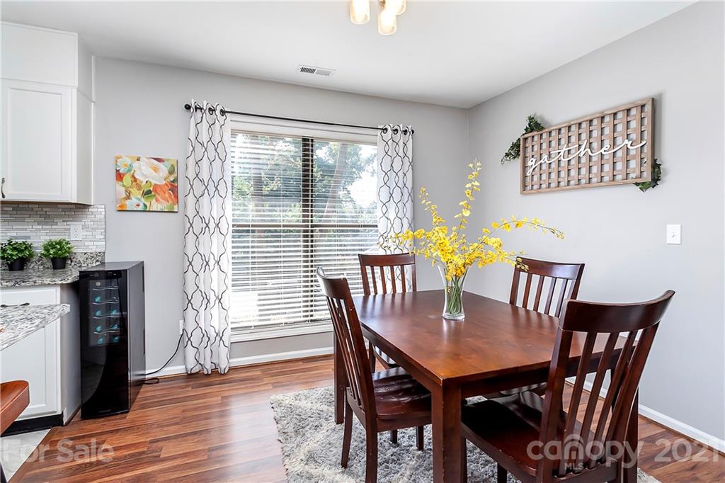 5063 Suwarrow Circle Tega Cay, SC 29708 - Photo 3 of 18 a view of a dining room with furniture window and wooden floor