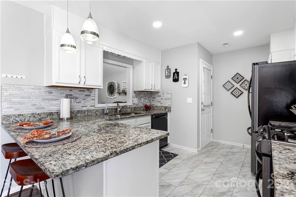 5063 Suwarrow Circle Tega Cay, SC 29708 - Photo 5 of 18 a kitchen with refrigerator and cabinets