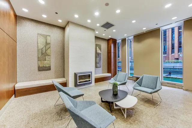 a living room with furniture and large windows