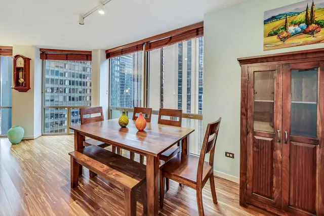 a view of a dining room with furniture window and wooden floor