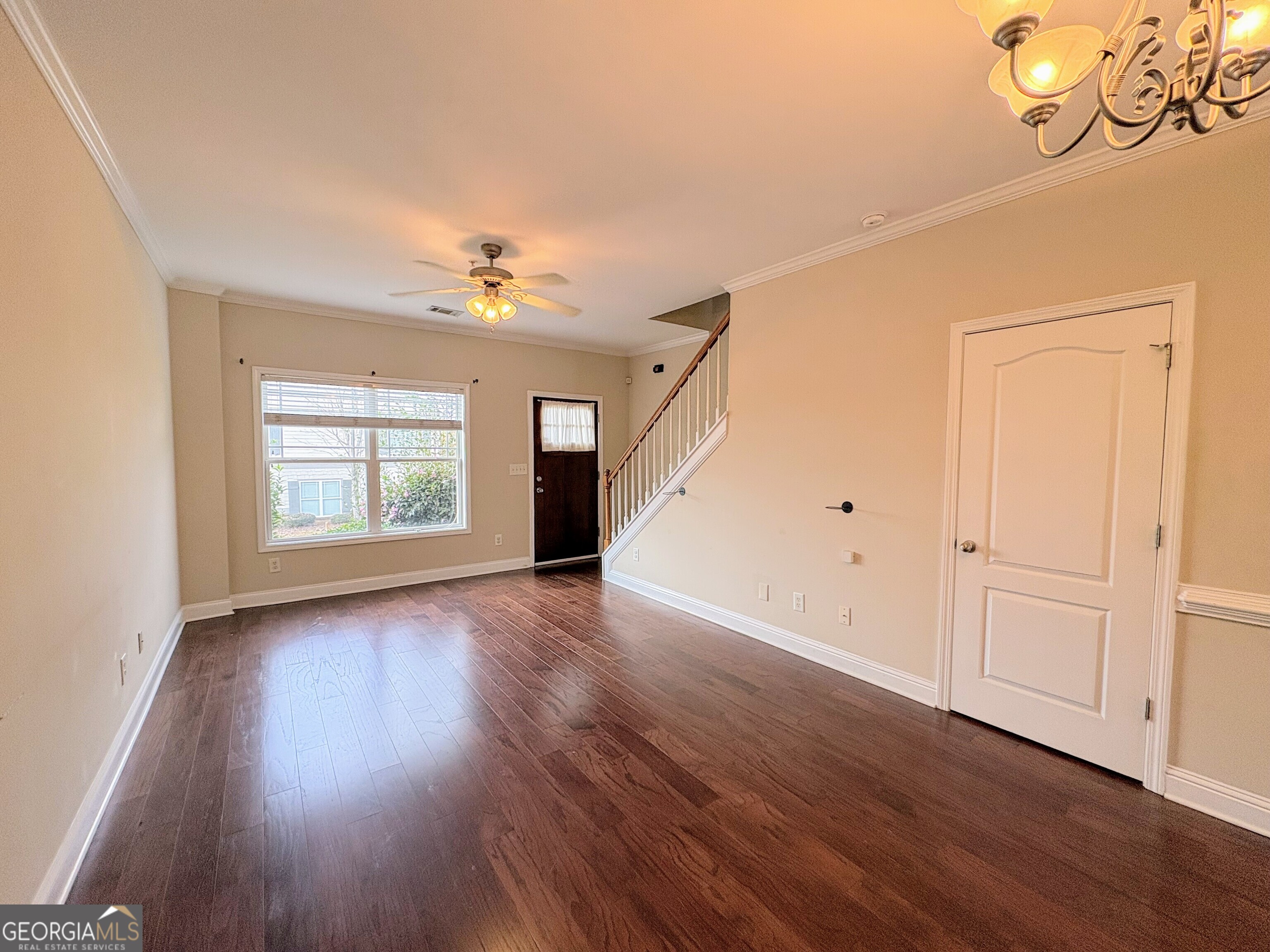 135 Oconee River Circle Athens, GA 30605 - Photo 3 of 17 an empty room with wooden floor cabinet and windows