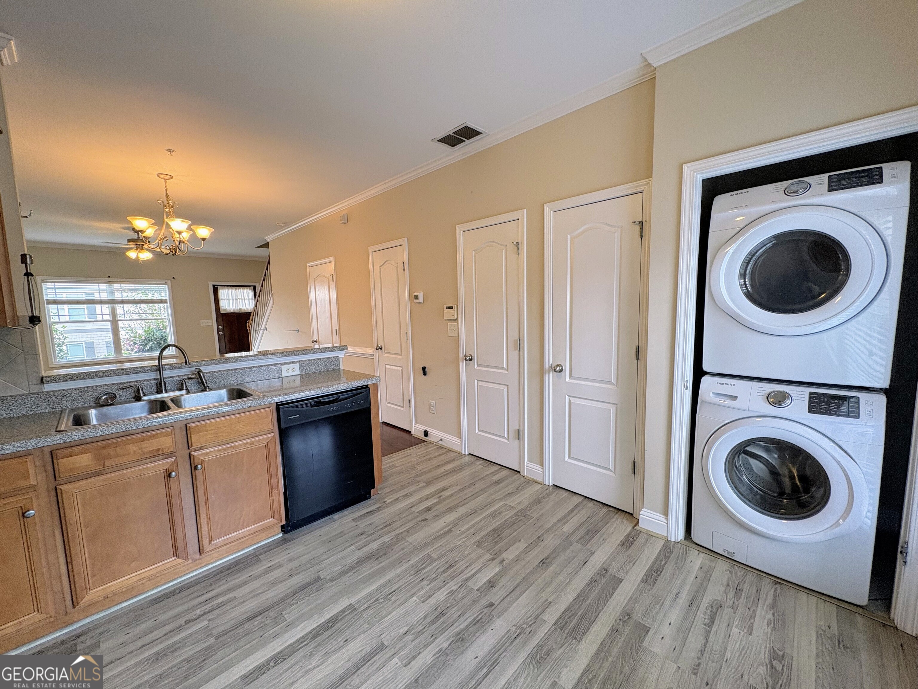 135 Oconee River Circle Athens, GA 30605 - Photo 5 of 17 a view of a kitchen with a sink a washer dryer and a washer dryer
