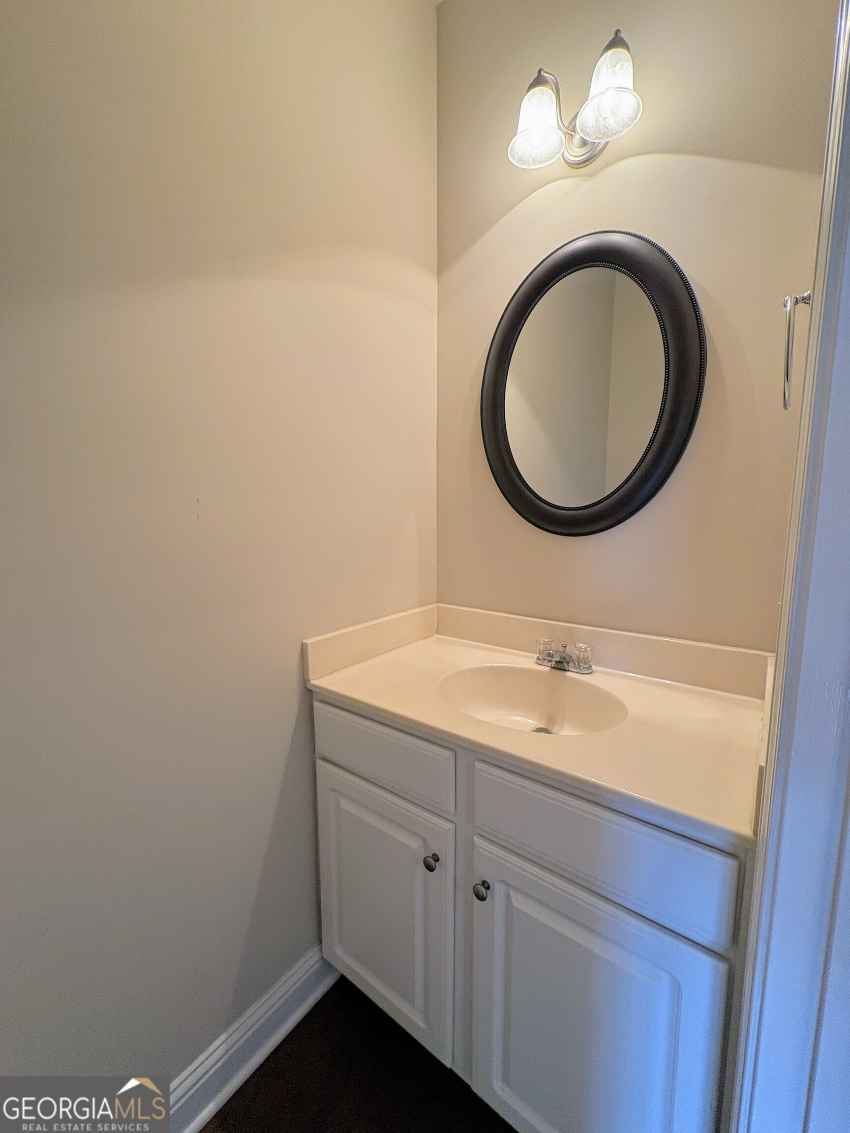 135 Oconee River Circle Athens, GA 30605 - Photo 6 of 17 a bathroom with a granite countertop toilet a sink and a mirror