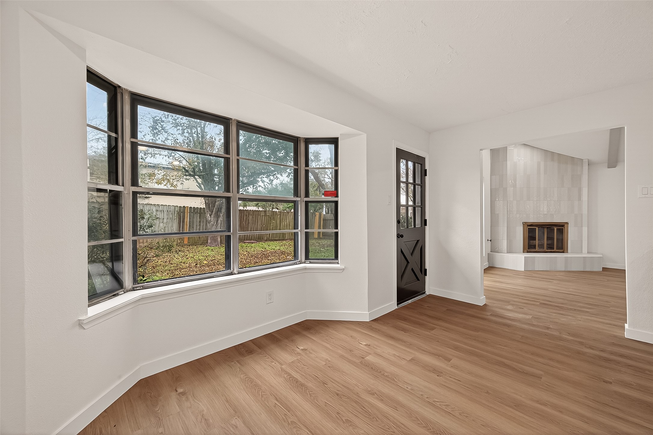 4415 Anacacho Street Pasadena, TX 77504 - Photo 13 of 45 a view of an empty room with wooden floor and a window