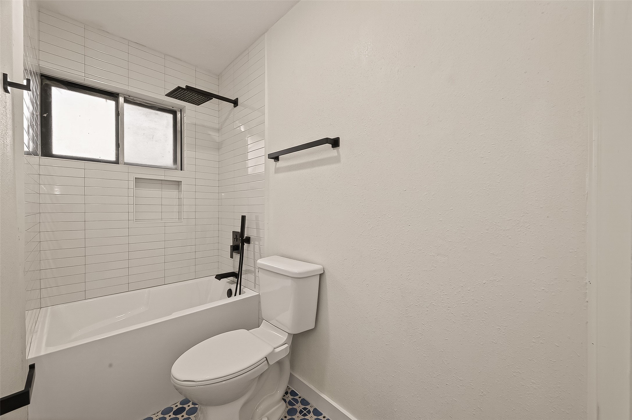 4415 Anacacho Street Pasadena, TX 77504 - Photo 24 of 45 a white toilet sitting next to a bath tub and a shower