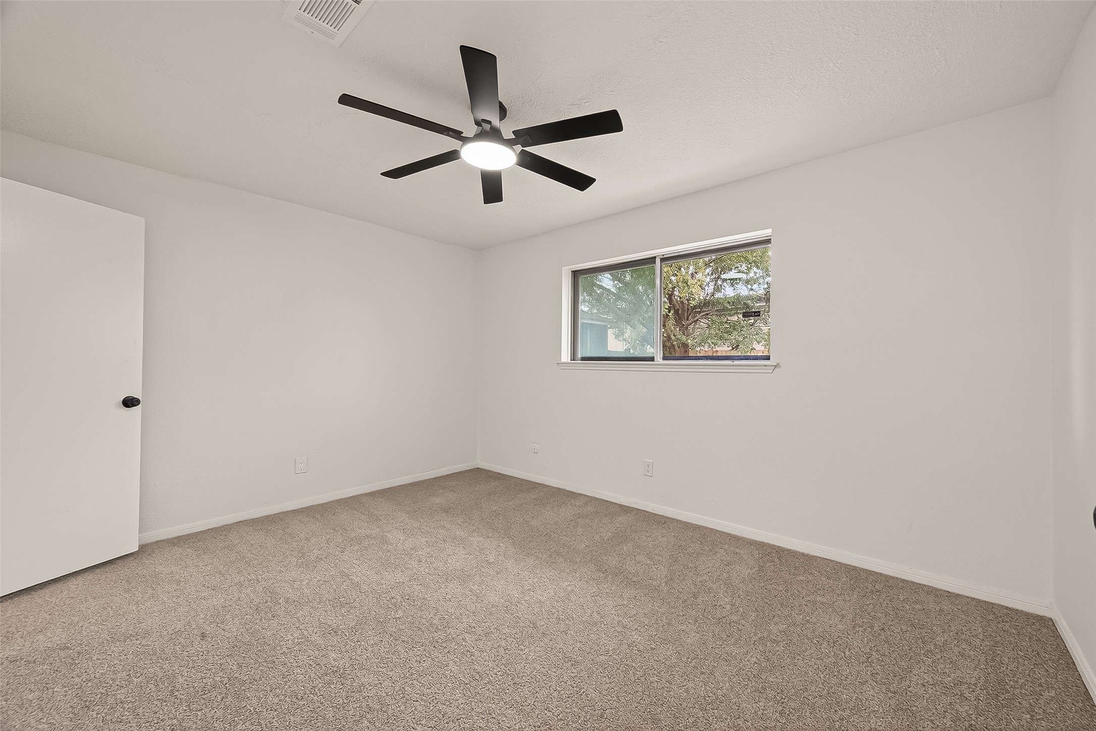 4415 Anacacho Street Pasadena, TX 77504 - Photo 26 of 45 an empty room with a window and a fan
