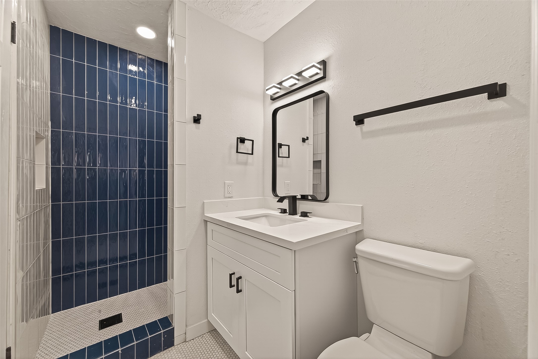 4415 Anacacho Street Pasadena, TX 77504 - Photo 28 of 45 a bathroom with a toilet a sink and mirror