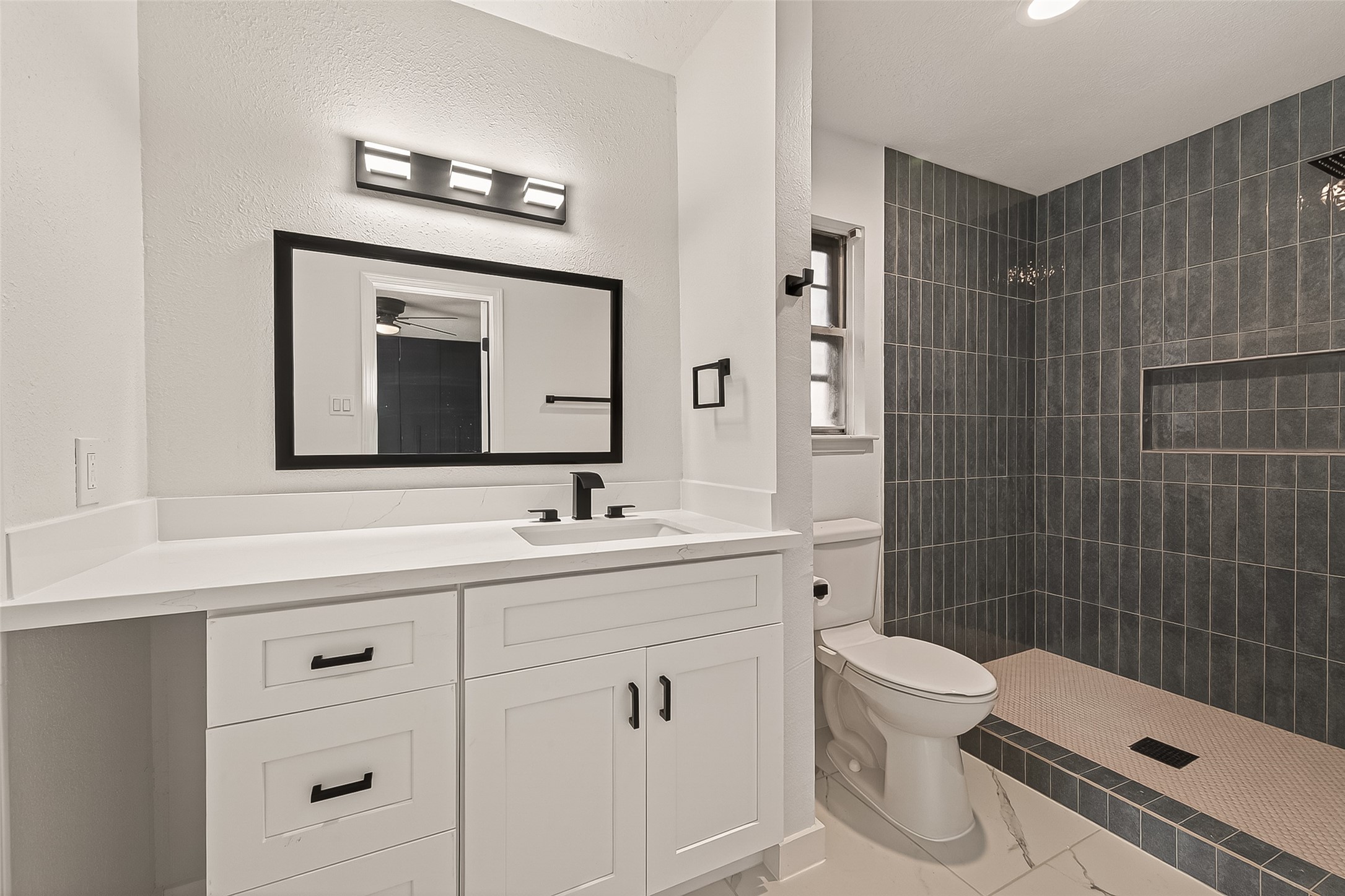 4415 Anacacho Street Pasadena, TX 77504 - Photo 33 of 45 a bathroom with a toilet sink vanity and mirror
