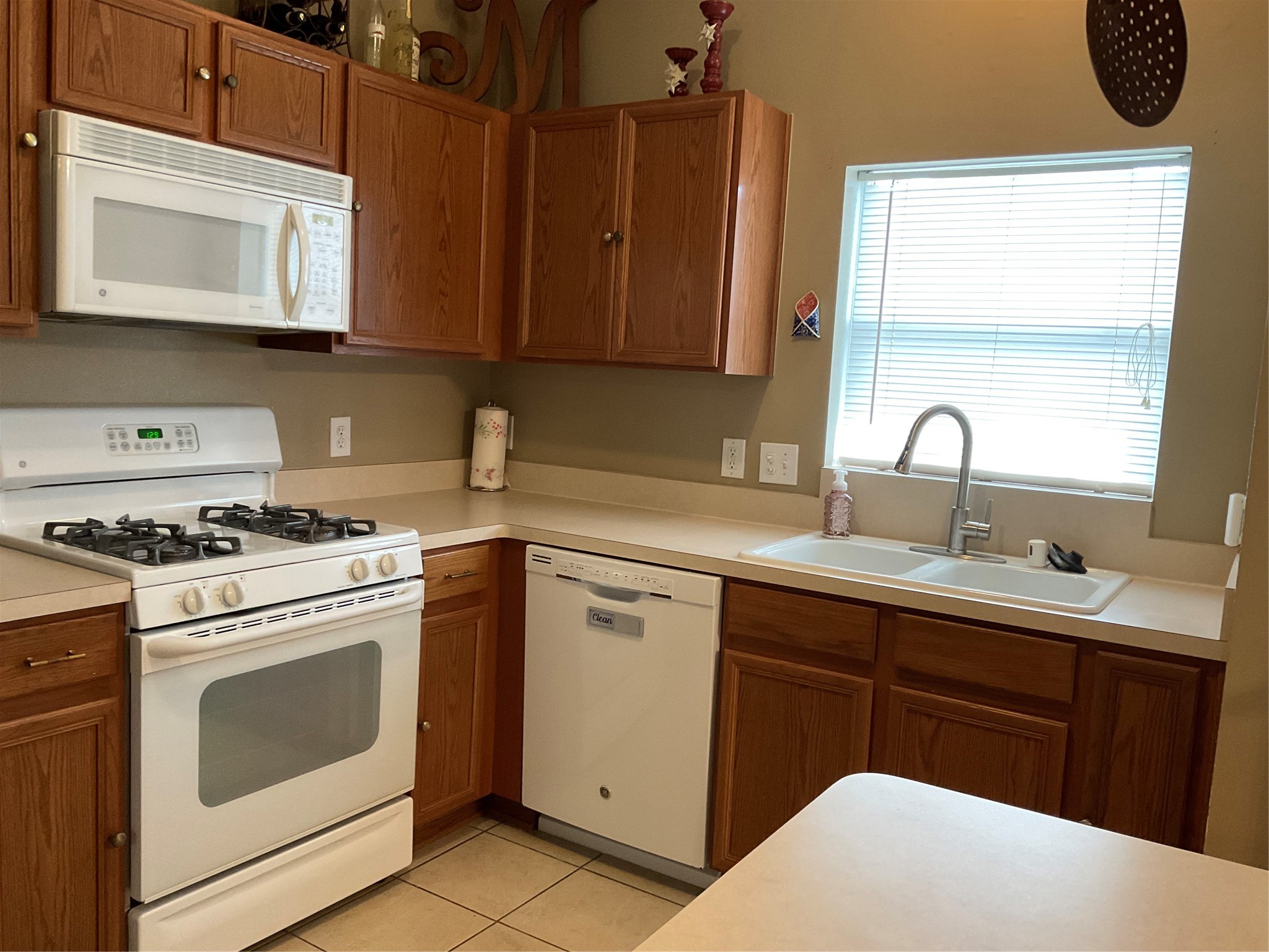 2110 Rustling Trees Way Spring, TX 77373 - Photo 13 of 36 All white appliance and a window at the sink.
