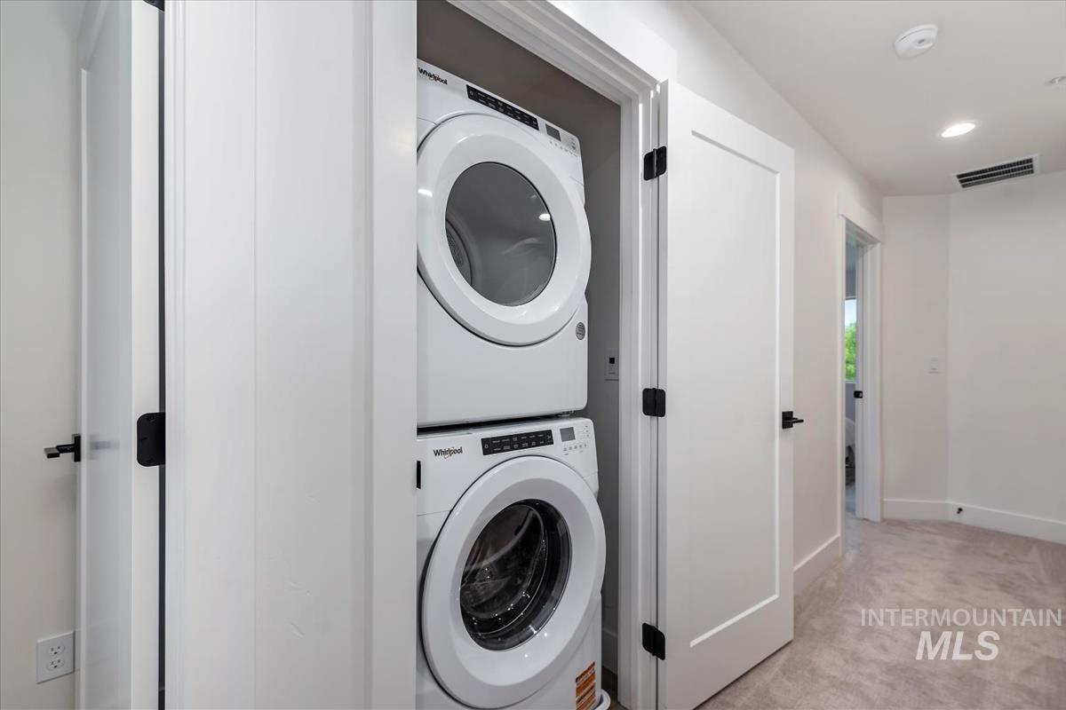 1705 South Federal Way Boise, ID 83705 - Photo 27 of 34 Laundry room featuring light colored carpet, estacked washer and dryer, and recessed lighting