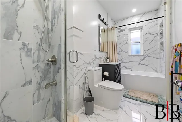 a bathroom with a toilet sink and shower