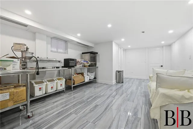 a large white kitchen with stainless steel appliances