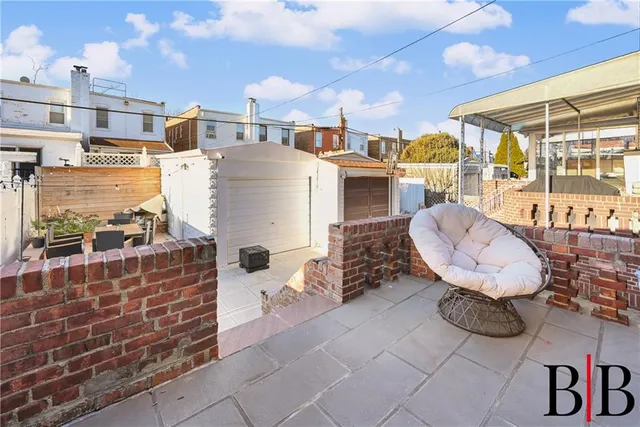 a view of a chairs and table in the backyard