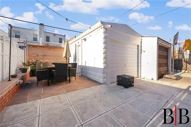 a roof deck with table and chairs