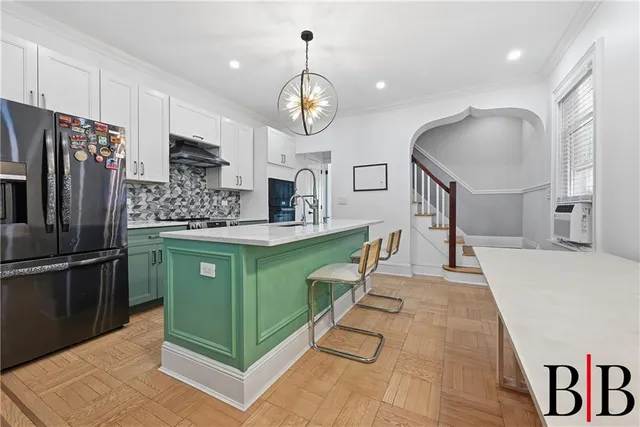 a kitchen with stainless steel appliances granite countertop a refrigerator a stove a sink and a refrigerator