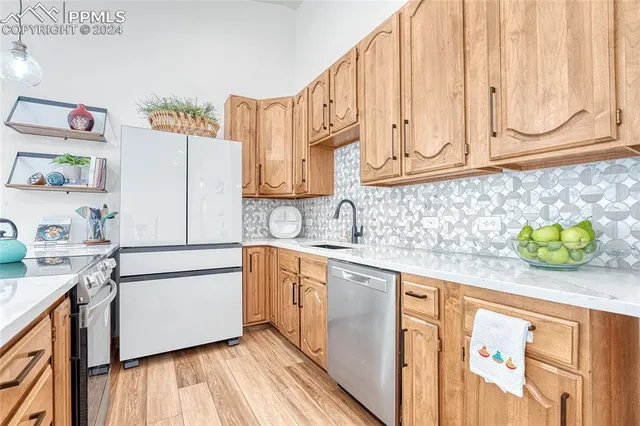 a white refrigerator freezer sitting inside of a kitchen