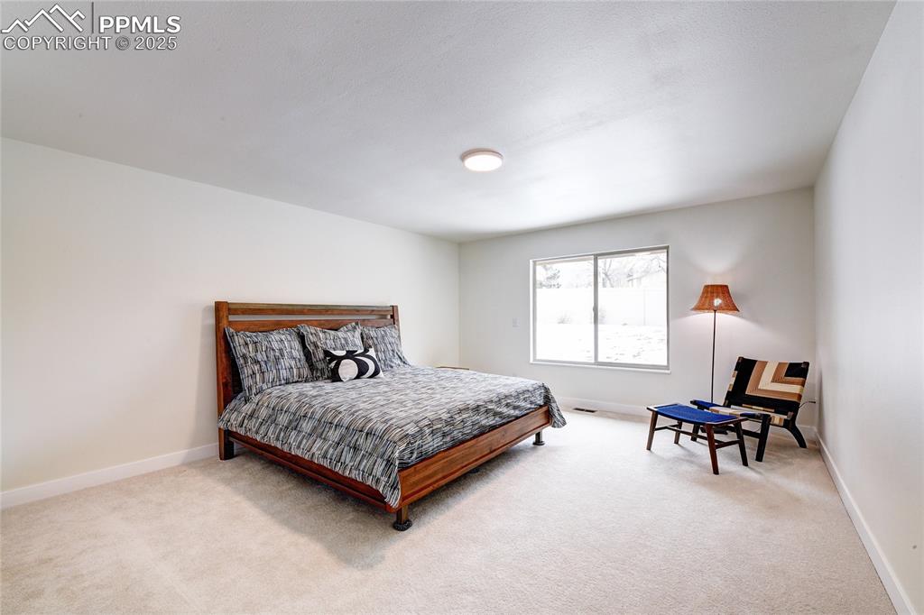 2004 Glenhill Road Colorado Springs, CO 80906 - Photo 19 of 43 a bedroom with a bed and a window