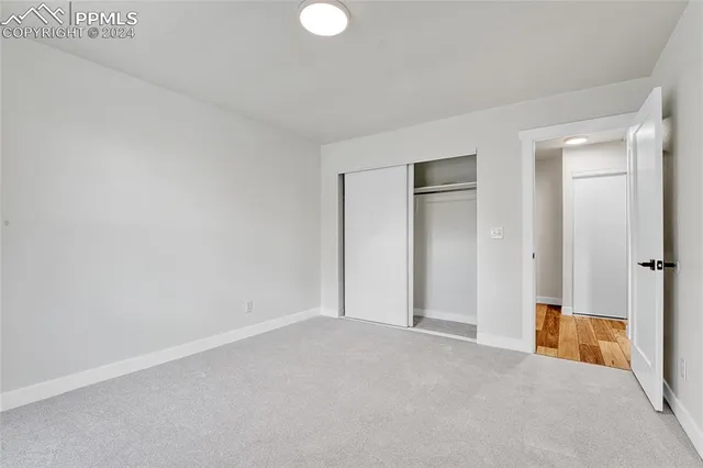 a view of an empty room and closet area