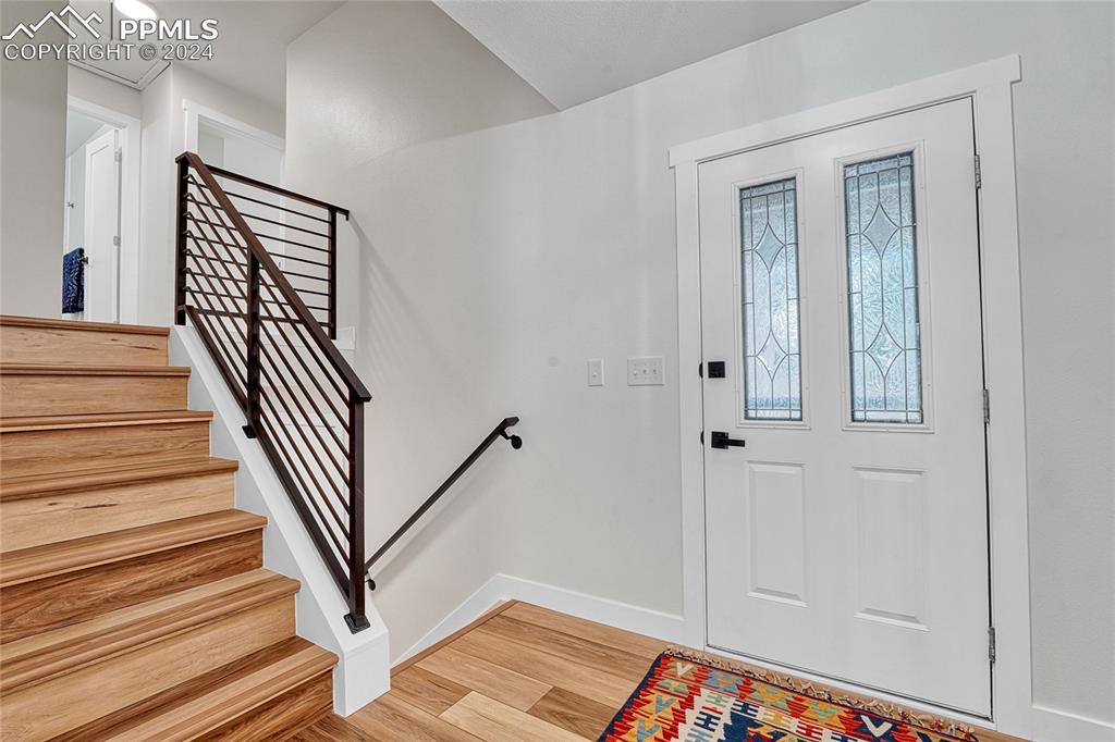 2004 Glenhill Road Colorado Springs, CO 80906 - Photo 3 of 43 a view of a hallway with wooden floor and staircase