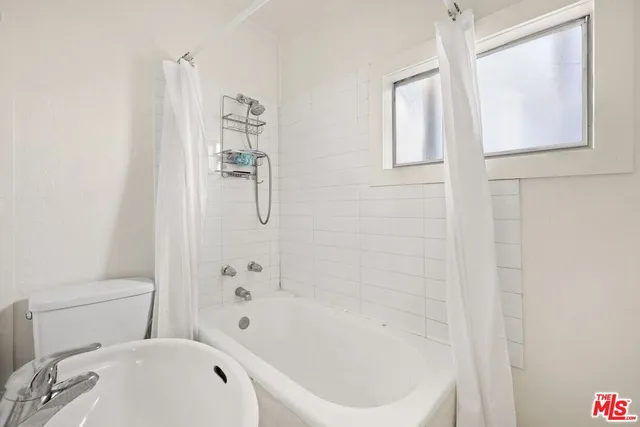 a bathroom with a bathtub and a shower