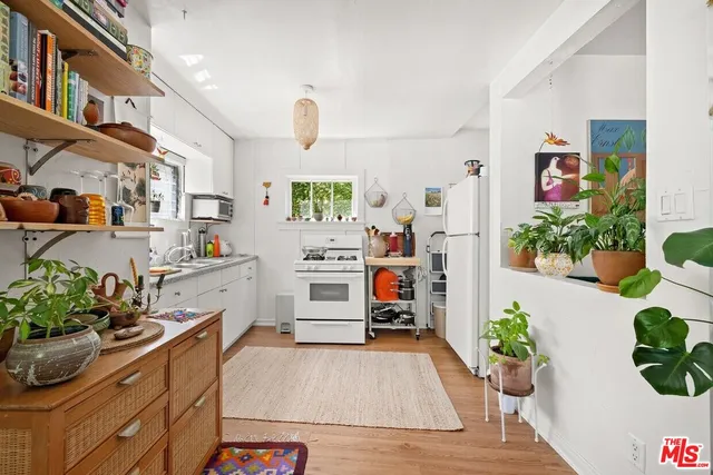 a kitchen with stainless steel appliances kitchen island granite countertop a refrigerator and a stove