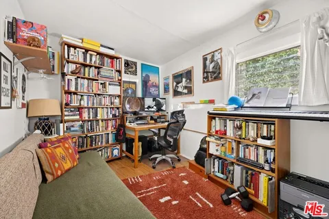 a living room with furniture a book shelf and a book shelf