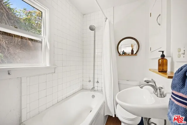 a bathroom with a sink a toilet and a bathtub