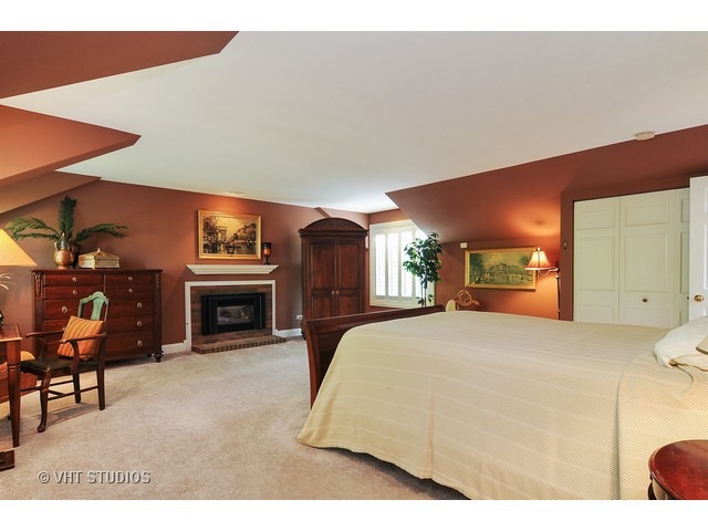14 West Sunset Road Chicago, IL 60647 - Photo 11 of 25 a spacious bedroom with a bed and a fireplace