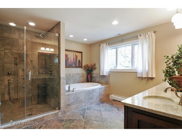 14 West Sunset Road Chicago, IL 60647 - Photo 12 of 25 a bathroom with a granite countertop sink a shower a mirror and a bathtub