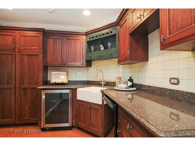 14 West Sunset Road Chicago, IL 60647 - Photo 18 of 25 a kitchen with stainless steel appliances granite countertop a sink stove and cabinets