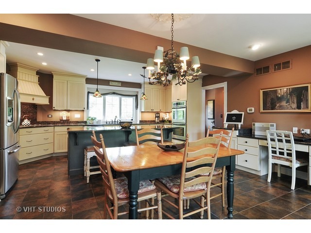 14 West Sunset Road Chicago, IL 60647 - Photo 5 of 25 a view of a dining room and livingroom with furniture a chandelier and wooden floor