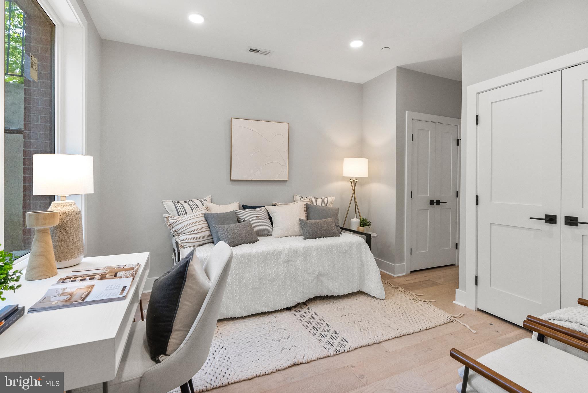 2019 M Street Northeast, Unit 1 Washington, DC 20002 - Photo 11 of 31 a bedroom with a bed and a mirror