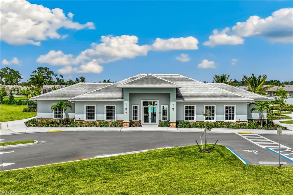 413 Grace Bay Lane Naples, FL 34114 - Photo 9 of 11 a front view of a house with a yard