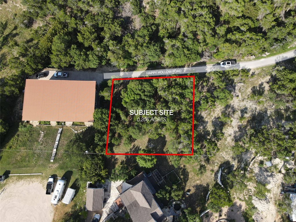 19525 Happy Hollow Road Spicewood, TX 78669 - Photo 5 of 8 a view of a yard with plants