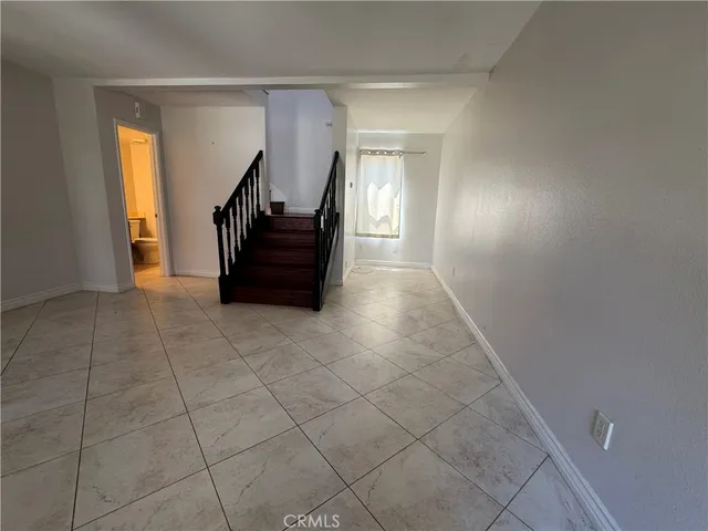 a view of a hallway with entryway and stairs