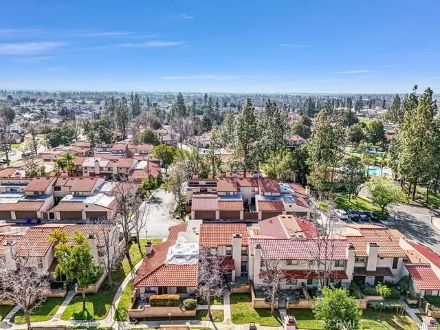 an aerial view of residential houses with city view