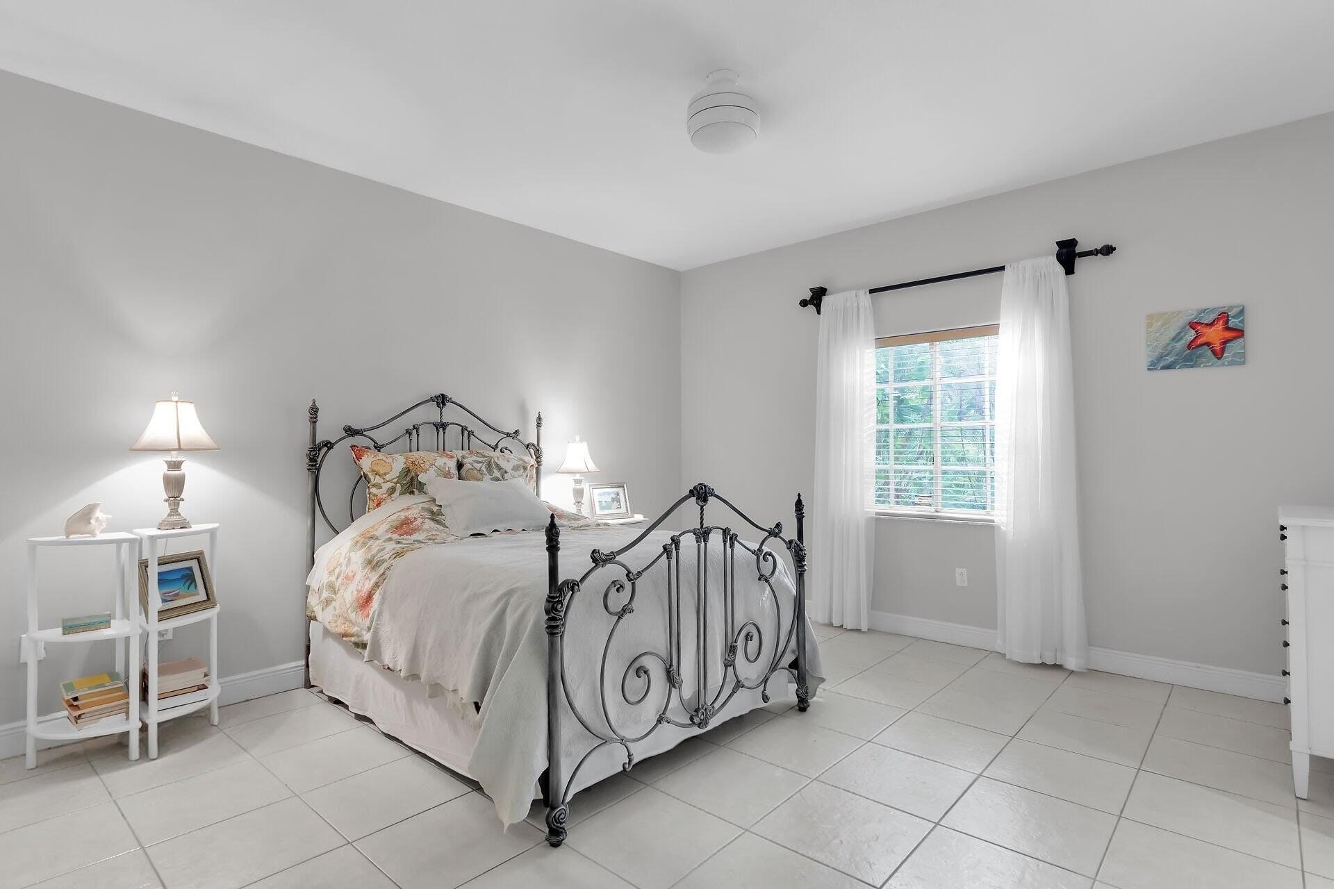 6 Fishermans Trail Key Largo, FL 33037 - Photo 13 of 50 a bed room with a bed and a chair