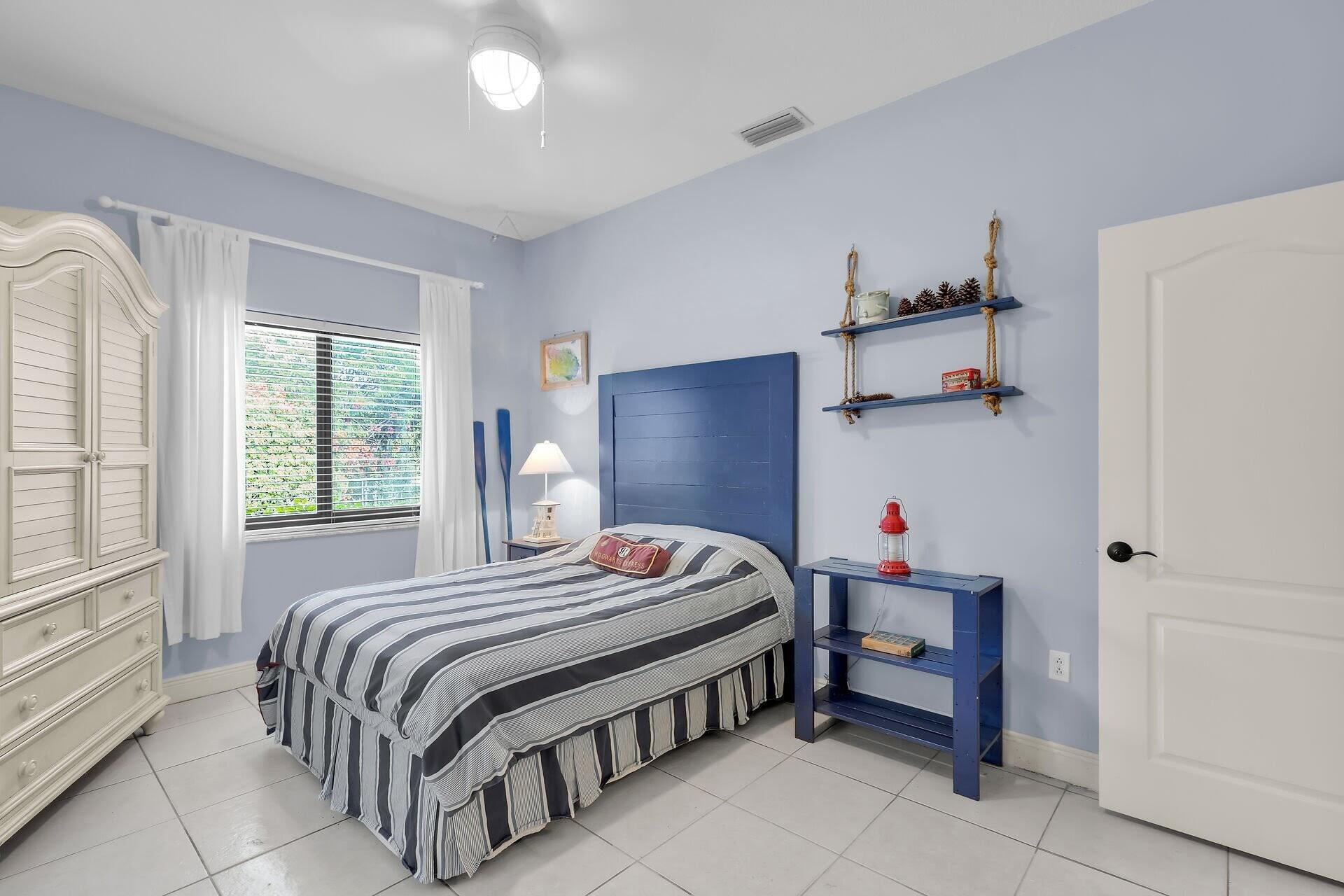 6 Fishermans Trail Key Largo, FL 33037 - Photo 19 of 50 a bedroom with a bed and a window