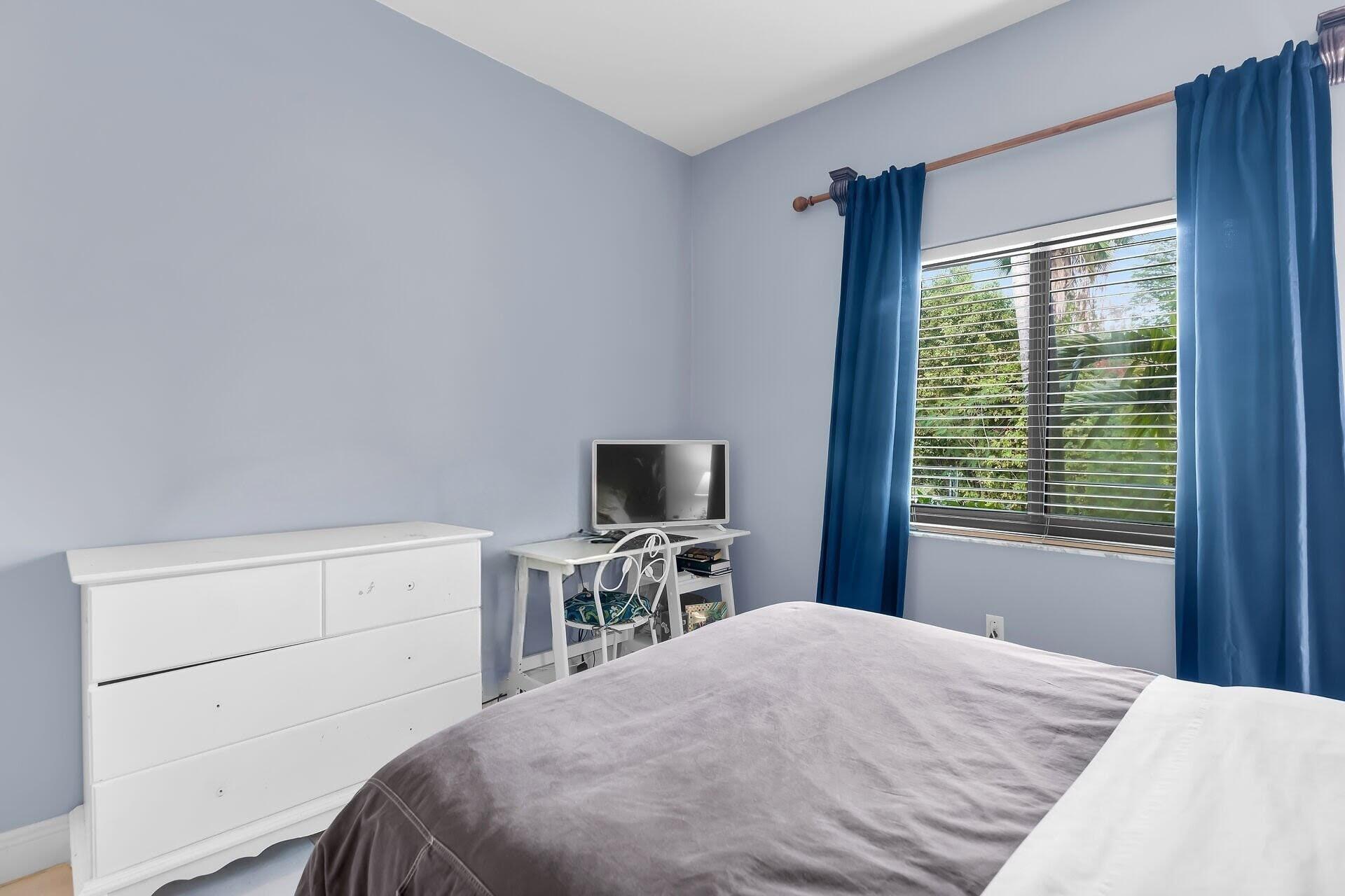 6 Fishermans Trail Key Largo, FL 33037 - Photo 24 of 50 a bedroom with a bed and a flat screen tv