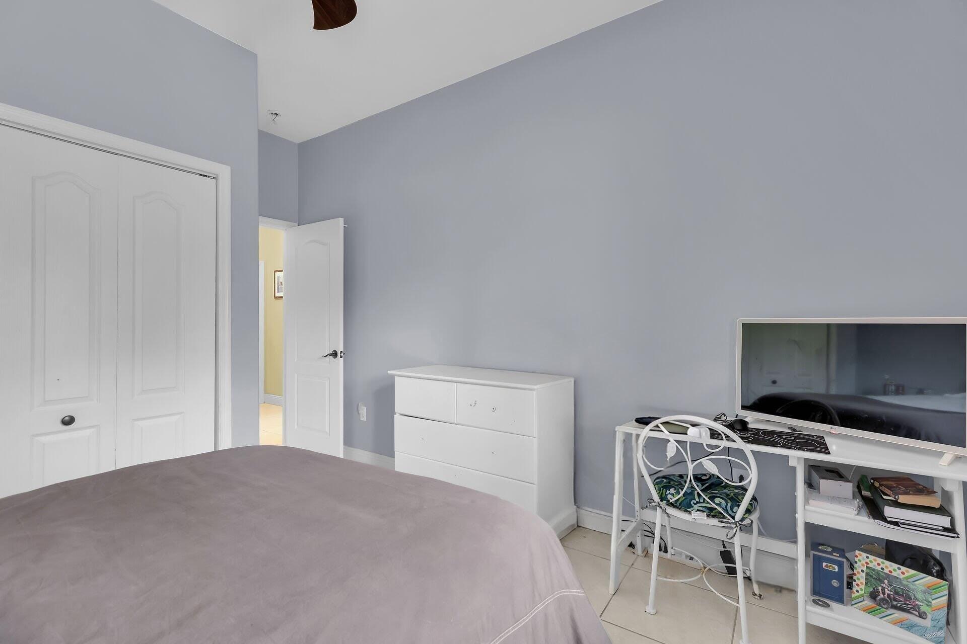 6 Fishermans Trail Key Largo, FL 33037 - Photo 25 of 50 a bedroom with a bed and a flat screen tv